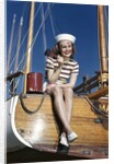 1940s Smiling Woman Wearing Nautical Sailor Outfit And Hat Sitting On Edge Of Boat Holding Paint Brush by Anonymous