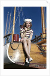 1940s Smiling Woman Wearing Nautical Sailor Outfit And Hat Sitting On Edge Of Boat Holding Paint Brush by Anonymous