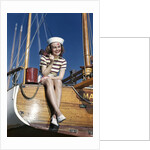1940s Smiling Woman Wearing Nautical Sailor Outfit And Hat Sitting On Edge Of Boat Holding Paint Brush by Anonymous