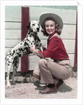 1940s 1950s Smiling Woman Wearing Western Cowgirl Outfit Kneeling Petting Dalmatian Dog by Anonymous