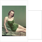 1940s Portrait Smiling Woman Wearing Green Velvet Bathing Suit Sitting Posing On Diving Board by Anonymous