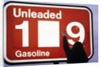 1980s Anonymous Unidentified Person Changing Gasoline Prices Sign by Anonymous
