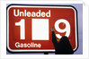 1980s Anonymous Unidentified Person Changing Gasoline Prices Sign by Anonymous
