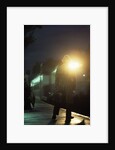 1970s 1980s Anonymous Man Commuter Waiting For Train Silhouetted By Bright Light by Anonymous