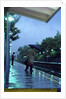 1970s 1980s Anonymous Business Man Holding Umbrella Waiting For A Commuter Train by Anonymous