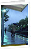 1970s 1980s Anonymous Business Man Holding Umbrella Waiting For A Commuter Train by Anonymous
