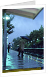 1970s 1980s Anonymous Business Man Holding Umbrella Waiting For A Commuter Train by Anonymous