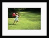 1980s Little Girl With A Red Balloon Running In The Grass by Anonymous
