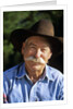 1990s Portrait Of Smiling Cowboy With Gray Mustache Black Hat Blue Shirt Looking At Camera by Corbis