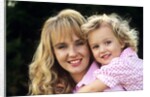 1990s Portrait Of Mother And Daughter Outdoors Looking At Camera Wearing Pink Shirts by Anonymous