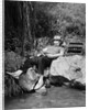 1950s Lazy Fisherman Lying Back On Rock With Hat Pulled Over Eyes Fishing In Creek by Anonymous