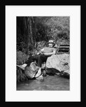 1950s Lazy Fisherman Lying Back On Rock With Hat Pulled Over Eyes Fishing In Creek by Anonymous