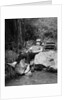 1950s Lazy Fisherman Lying Back On Rock With Hat Pulled Over Eyes Fishing In Creek by Anonymous