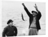 1950s 1960s Boy Son Fishing With Man Father Or Grandfather Holding Up Caught Fish On Line Laughing Having Fun by Corbis