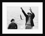 1950s 1960s Boy Son Fishing With Man Father Or Grandfather Holding Up Caught Fish On Line Laughing Having Fun by Anonymous
