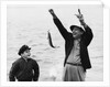 1950s 1960s Boy Son Fishing With Man Father Or Grandfather Holding Up Caught Fish On Line Laughing Having Fun by Anonymous