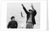 1950s 1960s Boy Son Fishing With Man Father Or Grandfather Holding Up Caught Fish On Line Laughing Having Fun by Anonymous
