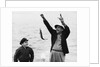 1950s 1960s Boy Son Fishing With Man Father Or Grandfather Holding Up Caught Fish On Line Laughing Having Fun by Anonymous