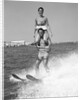 1960s Man Water Skiing With Woman In Bathing Suit Riding On Shoulders by Anonymous