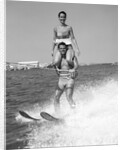 1960s Man Water Skiing With Woman In Bathing Suit Riding On Shoulders by Anonymous