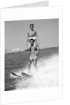 1960s Man Water Skiing With Woman In Bathing Suit Riding On Shoulders by Anonymous