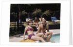 1960s Four People On Patio Couple Man Woman Sitting On Edge Of Swimming Pool by Anonymous