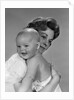 1960s Thoughtful Pensive Mother Holding Happy Baby Child by Anonymous