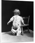 1930s Baby Wearing Drop Seat Pajamas Showing Bare Bottom Leaning On Chair by Anonymous