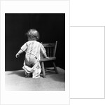 1930s Baby Wearing Drop Seat Pajamas Showing Bare Bottom Leaning On Chair by Anonymous