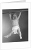 1960s Baby Hanging From Rod With Frightened Expression On Verge Of Tears by Anonymous