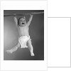 1960s Baby Hanging From Rod With Frightened Expression On Verge Of Tears by Anonymous