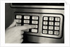 1980s Hand Pressing Buttons On Panel Of Vintage Automatic Teller Machine Atm by Anonymous