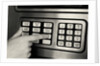 1980s Hand Pressing Buttons On Panel Of Vintage Automatic Teller Machine Atm by Anonymous
