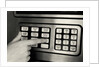 1980s Hand Pressing Buttons On Panel Of Vintage Automatic Teller Machine Atm by Anonymous