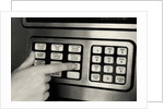 1980s Hand Pressing Buttons On Panel Of Vintage Automatic Teller Machine Atm by Anonymous