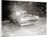 1950s Snow Covered Automobile Driving On Road In Deepening Winter Blizzard Snow by Anonymous