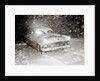 1950s Snow Covered Automobile Driving On Road In Deepening Winter Blizzard Snow by Anonymous