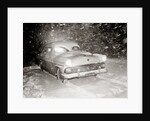 1950s Snow Covered Automobile Driving On Road In Deepening Winter Blizzard Snow by Anonymous