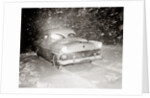 1950s Snow Covered Automobile Driving On Road In Deepening Winter Blizzard Snow by Anonymous