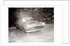 1950s Snow Covered Automobile Driving On Road In Deepening Winter Blizzard Snow by Anonymous