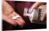 1990s Female Hand Taking Two Aspirin Tablets From Bottle by Anonymous
