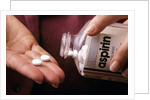 1990s Female Hand Taking Two Aspirin Tablets From Bottle by Anonymous