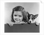 1940s 1950s Portrait Of Little Girl With Small Dog Looking At Camera by Anonymous