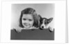 1940s 1950s Portrait Of Little Girl With Small Dog Looking At Camera by Anonymous