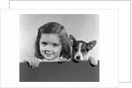 1940s 1950s Portrait Of Little Girl With Small Dog Looking At Camera by Anonymous