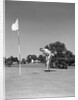 1950s Man Playing Golf Putting Golf Ball On Green To Flag And Cup Outdoor by Anonymous