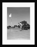 1950s Man Playing Golf Putting Golf Ball On Green To Flag And Cup Outdoor by Anonymous