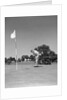 1950s Man Playing Golf Putting Golf Ball On Green To Flag And Cup Outdoor by Anonymous
