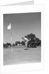 1950s Man Playing Golf Putting Golf Ball On Green To Flag And Cup Outdoor by Anonymous