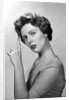 1950s Concerned Woman With Reminder String Knot Tied On Finger Of Hand To Help Remember Something Looking At Camera by Anonymous
